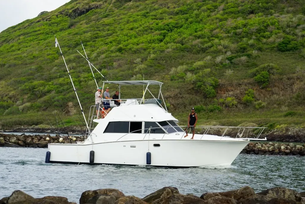 Go Fish Kauai captain on the flybridge of the Emma Nalani