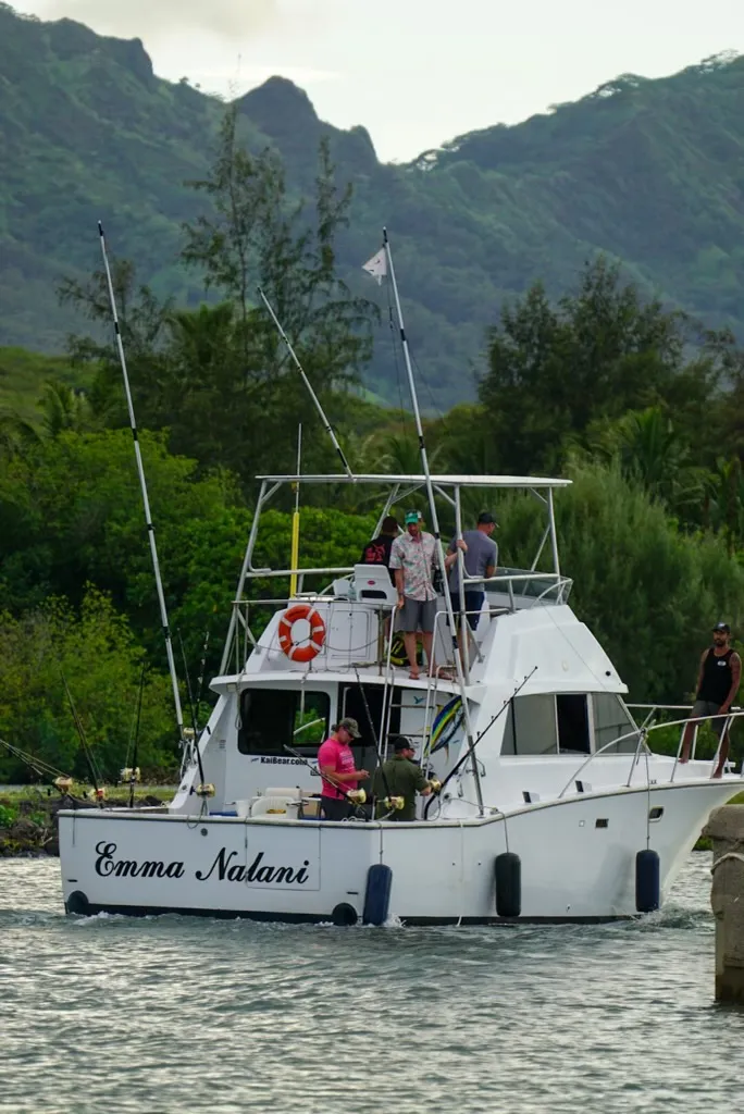 Go Fish Kauai mate working the lines on the Emma Nalani