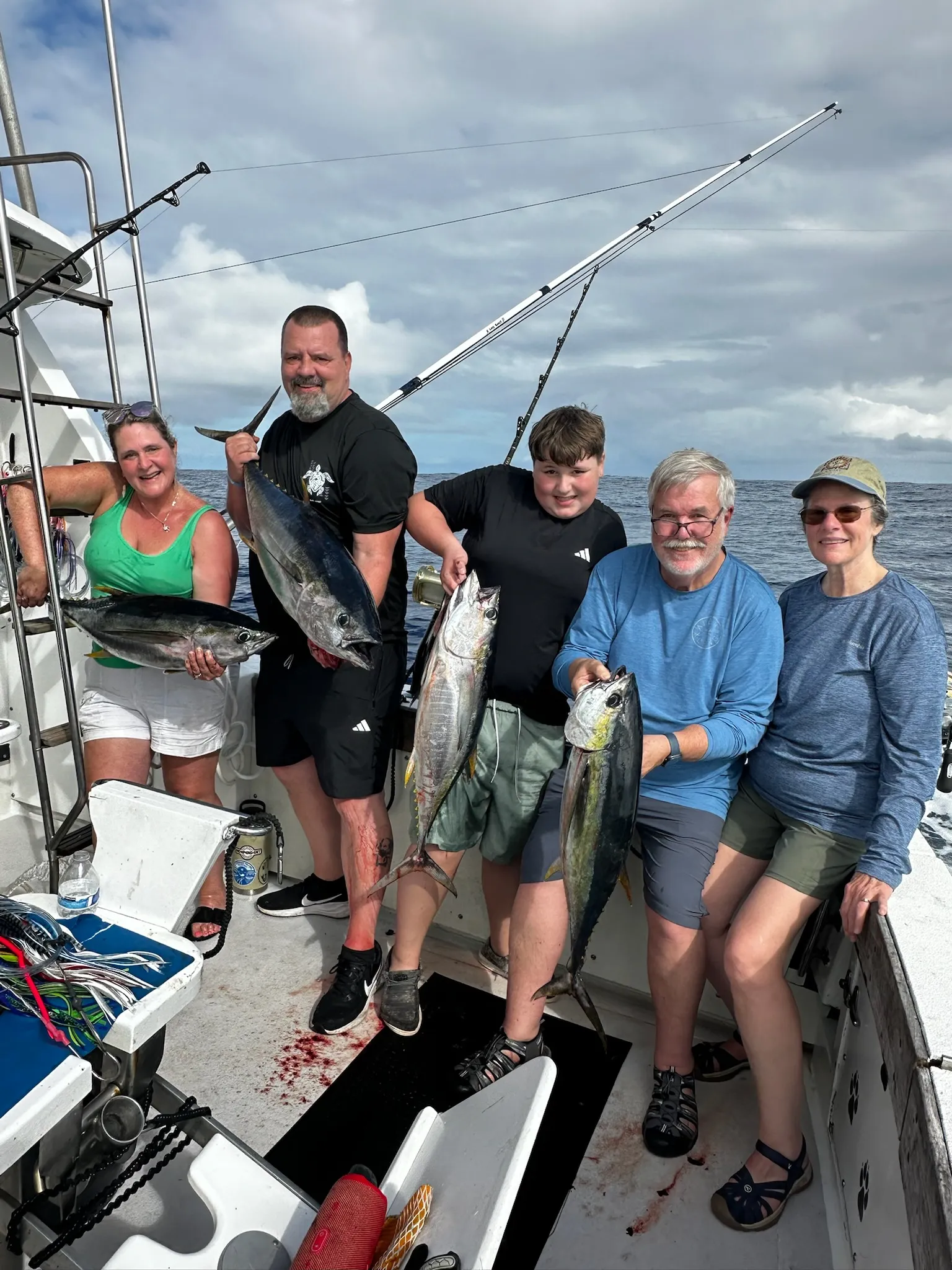 Young angler with first fish on a Go Fish Kauai charter