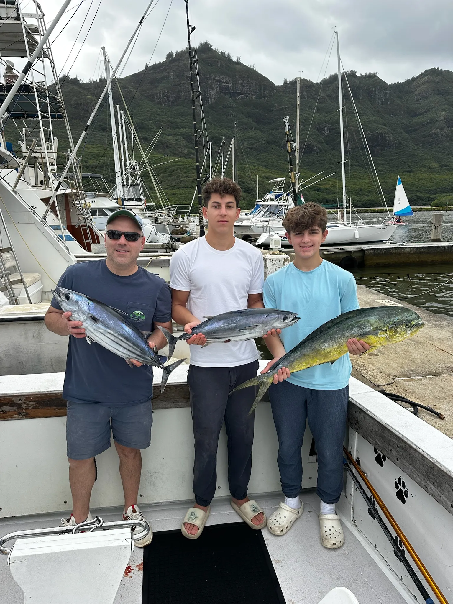 Dog and angler together on the Emma Nalani pet-friendly fishing charter